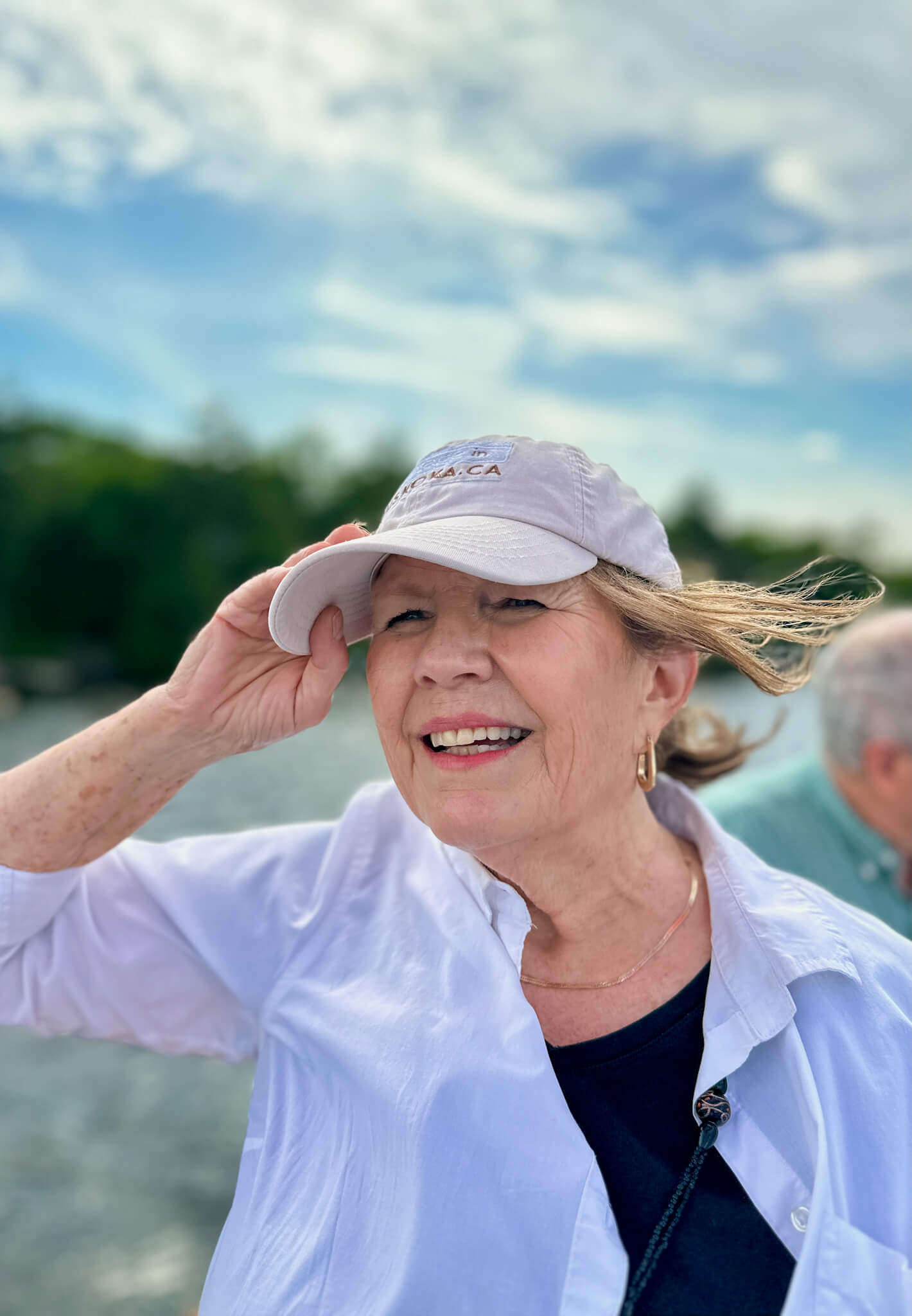 Catharine from Cottage in Muskoka smiling on a boat, out on the water on Lake Rosseau helping cottage buyers in Muskoka