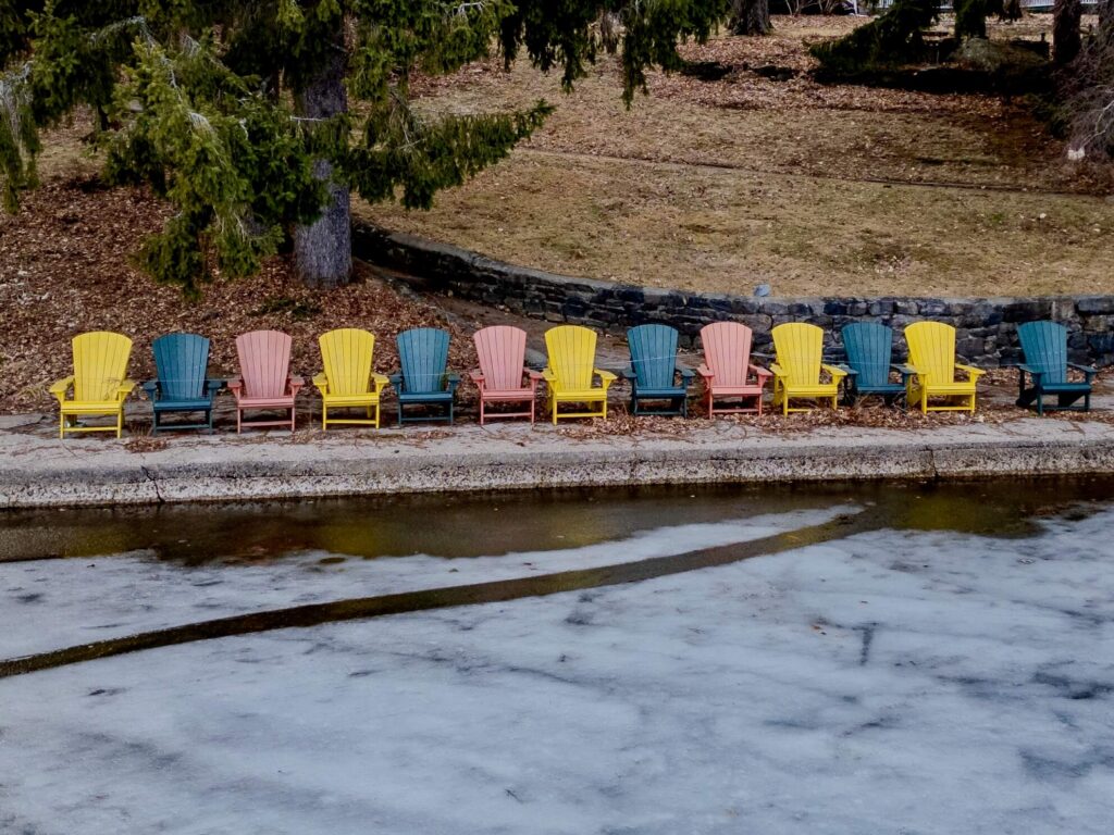 The iconic Muskoka chairs along the Clevelands House shoreline on Lake Rosseau