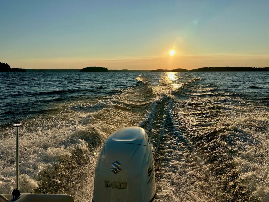 Boat wake on Lake Muskoka at sunset