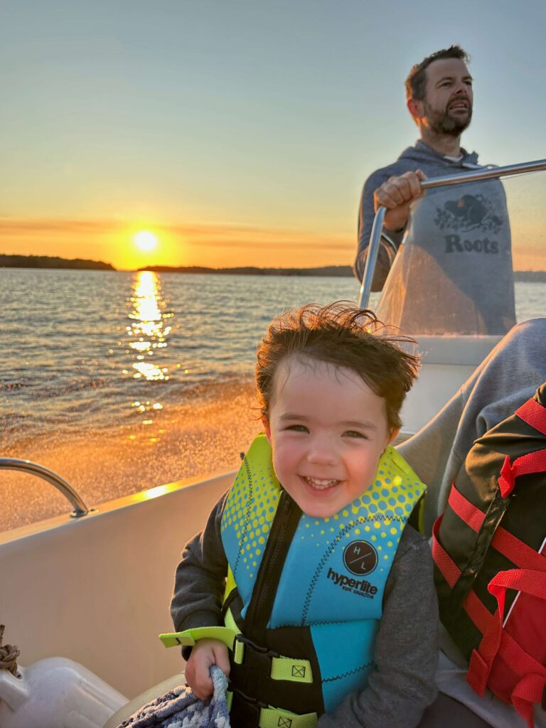 Toddler in a lifejacket on a family boat ride on Lake Muskoka